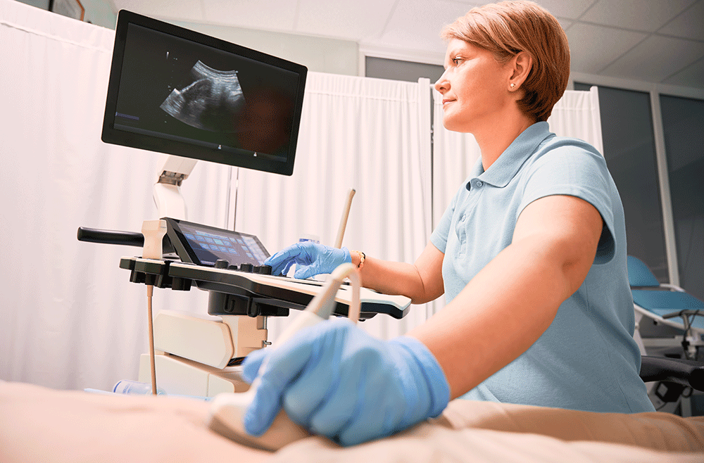 Female-sonographer-examining-woman-with-ultrasound-scanner_shutterstock_1996770377